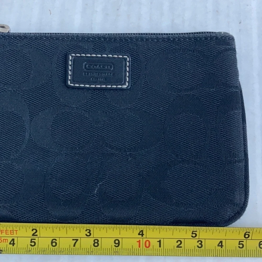 Coach black signature C mini wristlet.